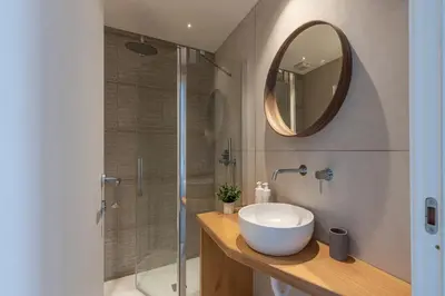 a bathroom with a sink and a shower with a mirror at Casa Valverde in Centro Storico by Wonderful Italy in Palermo