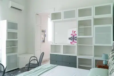 a bedroom with green and white shelves and a bed at B&B da Nonna Cicci APT vicino al Teatro Massimo in Palermo