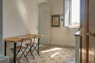 a kitchen with a table and chairs in a room at B&B da Nonna Cicci APT vicino al Teatro Massimo in Palermo