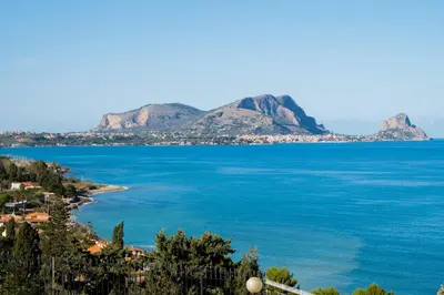a view of the ocean with mountains in the background at Villa Carilù in Altavilla Milicia