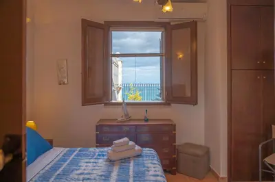 a bedroom with a bed with a window and a dresser at Villa Carilù in Altavilla Milicia