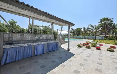 a patio with a bar and a swimming pool at Awesome Home In Partinico With Wi-Fi in Partinico