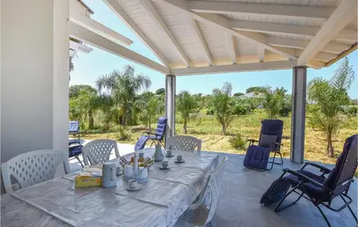 a table and chairs on a patio with a view at Awesome Home In Partinico With Wi-Fi in Partinico