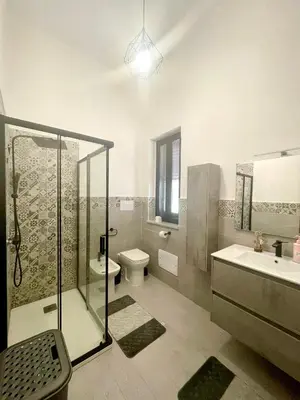 a bathroom with a shower and a toilet and a sink at Villa Nasus in Carini