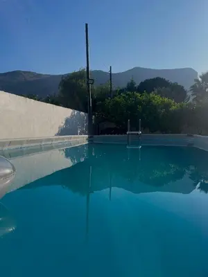 a swimming pool with a clear blue water at Villa Nasus in Carini