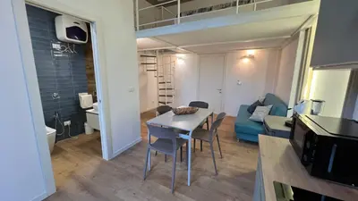 a small living room with a table and a couch at Le Stanze del Re in Palermo