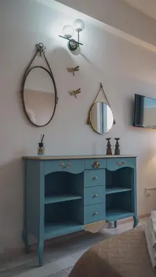 a blue dresser in a bedroom with a mirror at [jarase] nel centro di Palermo in Palermo