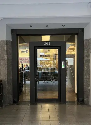 an entrance to a store with a glass door at [jarase] nel centro di Palermo in Palermo