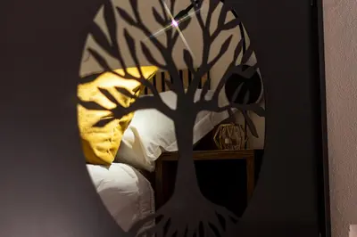 a reflection of a tree in a mirror at Teama House - Appartamento in centro - Politeama in Palermo