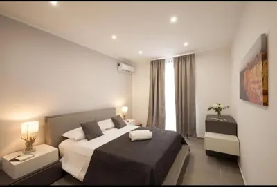 a bedroom with a large bed and a window at Holiday hause Vite Aerea in Terrasini