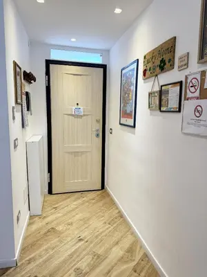 a hallway with a door and a wooden floor at Lucky Home Palermo in Palermo