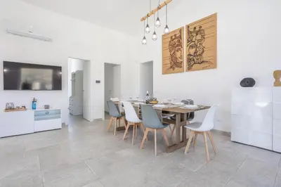 a kitchen and dining room with a table and chairs at Villa Aurora in Balata di Baida