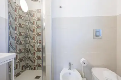 a bathroom with a shower and a toilet and a sink at Villa Aurora in Balata di Baida