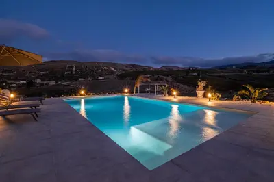 a swimming pool at night with a view at Villa Aurora in Balata di Baida