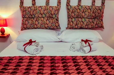 a bed with two rolls of towels on it at Alba e i Mori in Palermo