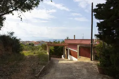 a road leading to a building with a red roof at Villetta dei Tramonti in Trappeto