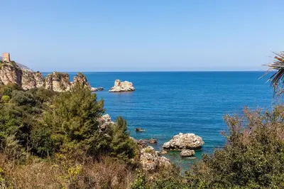 a view of the ocean with rocks in the water at Villa La Fenice by Wonderful Italy in Castellammare del Golfo