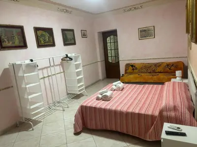 a bedroom with a bed with two teddy bears on it at Casa Vacanze Madison Square in Palermo