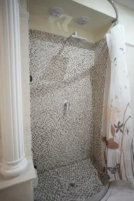 a bathroom with a shower with a tiled shower at Casa Vacanze Madison Square in Palermo