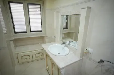 a white bathroom with a sink and a mirror at Casa Vacanze Madison Square in Palermo