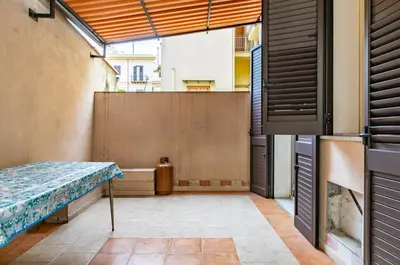 a view of a balcony with a table in a room at Teatro Massimo Roomy Flat with Covered Terrace in Palermo