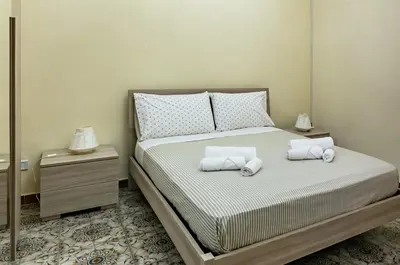 a bedroom with a bed with two pillows on it at Teatro Massimo Roomy Flat with Covered Terrace in Palermo