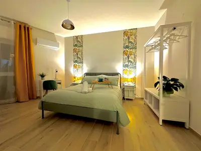 a bedroom with a bed in a room at Merlo Holiday Homes Siviglia in Palermo