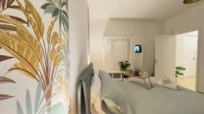 a bedroom with a bed with a painting on the wall at Merlo Holiday Homes Siviglia in Palermo