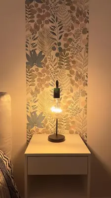 a lamp on a table in front of a wall at Merlo Holiday Homes Siviglia in Palermo