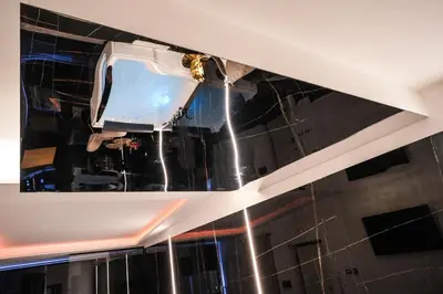 a worker painting the ceiling of a building at Superior Suite Palermo in Palermo