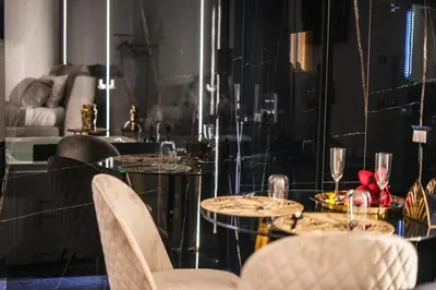 a dining room with a table with chairs and wine glasses at Superior Suite Palermo in Palermo