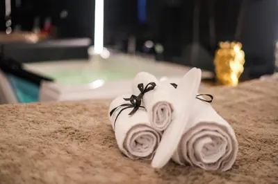 a white towel with roses on top of a table at Superior Suite Palermo in Palermo