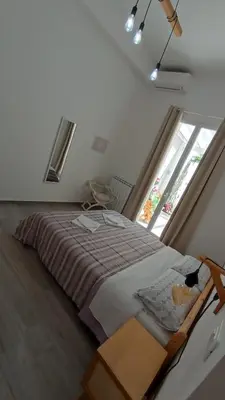 a bedroom with a large bed with a window at Tati's Garden in Palermo