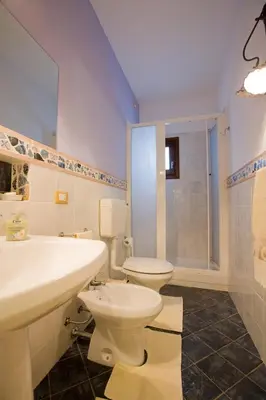 a bathroom with a toilet and a sink and a shower at Sicilia Ovest - Domus Mariae Charming Apartments with Balcony in Castellammare del Golfo