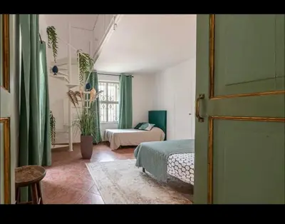 a room with a bedroom with a bed and a window at Donna Isabella a Ballarò in Palermo