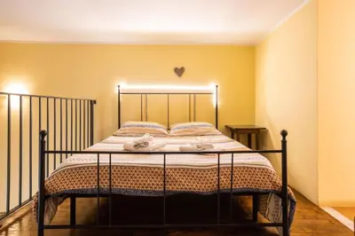 a bed in a room with yellow walls at Hola House allo Spasimo in Palermo