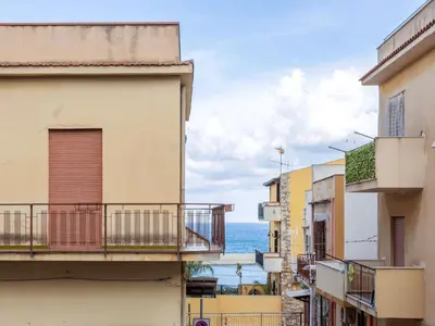 a view of the ocean from between buildings at Apartment Sicilia by Interhome in Balestrate