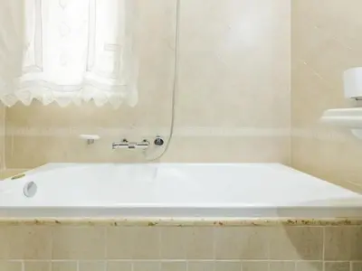 a white bath tub in a bathroom with a window at CASA VACANZE PERLA in Partinico