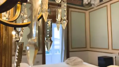 a dining room with a chandelier and a table at Heritage Collection Palermo B&B in Palermo