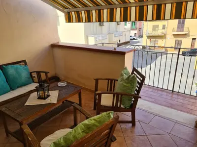a room with a balcony with a table and chairs at Holiday House Giorgia in Terrasini
