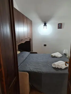 a bedroom with a bed with two towels on it at Holiday House Giorgia in Terrasini