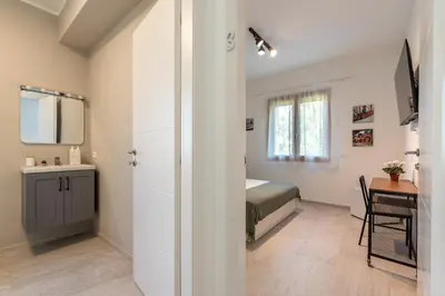 a small bedroom with a bed and a table at Villetta Hilda by Wonderful Italy in Mondello