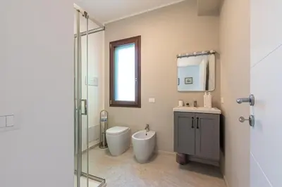 a bathroom with a toilet and a sink and a shower at Villetta Hilda by Wonderful Italy in Mondello