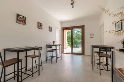 a living room with stools and tables in a room at Villetta Hilda by Wonderful Italy in Mondello