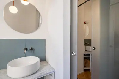 a bathroom with a white sink and a mirror at Casa Mirto a Piazza Marina by Wonderful Italy in Palermo