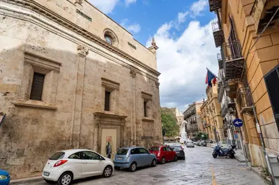 a street with cars parked on the side of a building at Casa Mirto a Piazza Marina by Wonderful Italy in Palermo