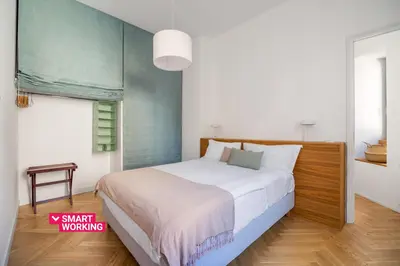 a bedroom with a large white bed in a room at Casa Mirto a Piazza Marina by Wonderful Italy in Palermo