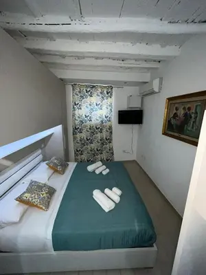 a bedroom with a bed with two towels on it at Capobeb in Palermo