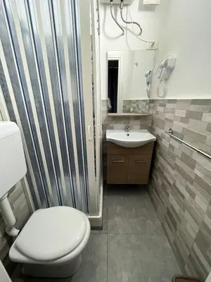 a bathroom with a toilet and a sink at Capobeb in Palermo