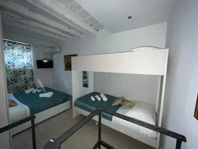 a bedroom with two bunk beds and a balcony at Capobeb in Palermo